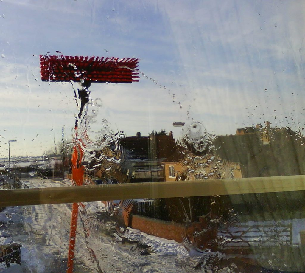 Photo of a water fed pole cleaning a second story window